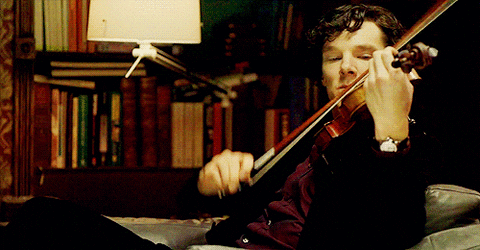 image1 A man playing the violin in front of some books.