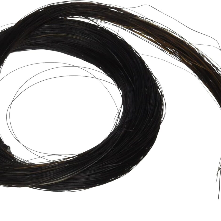 A black hair extension is curled in the middle of it's curl.